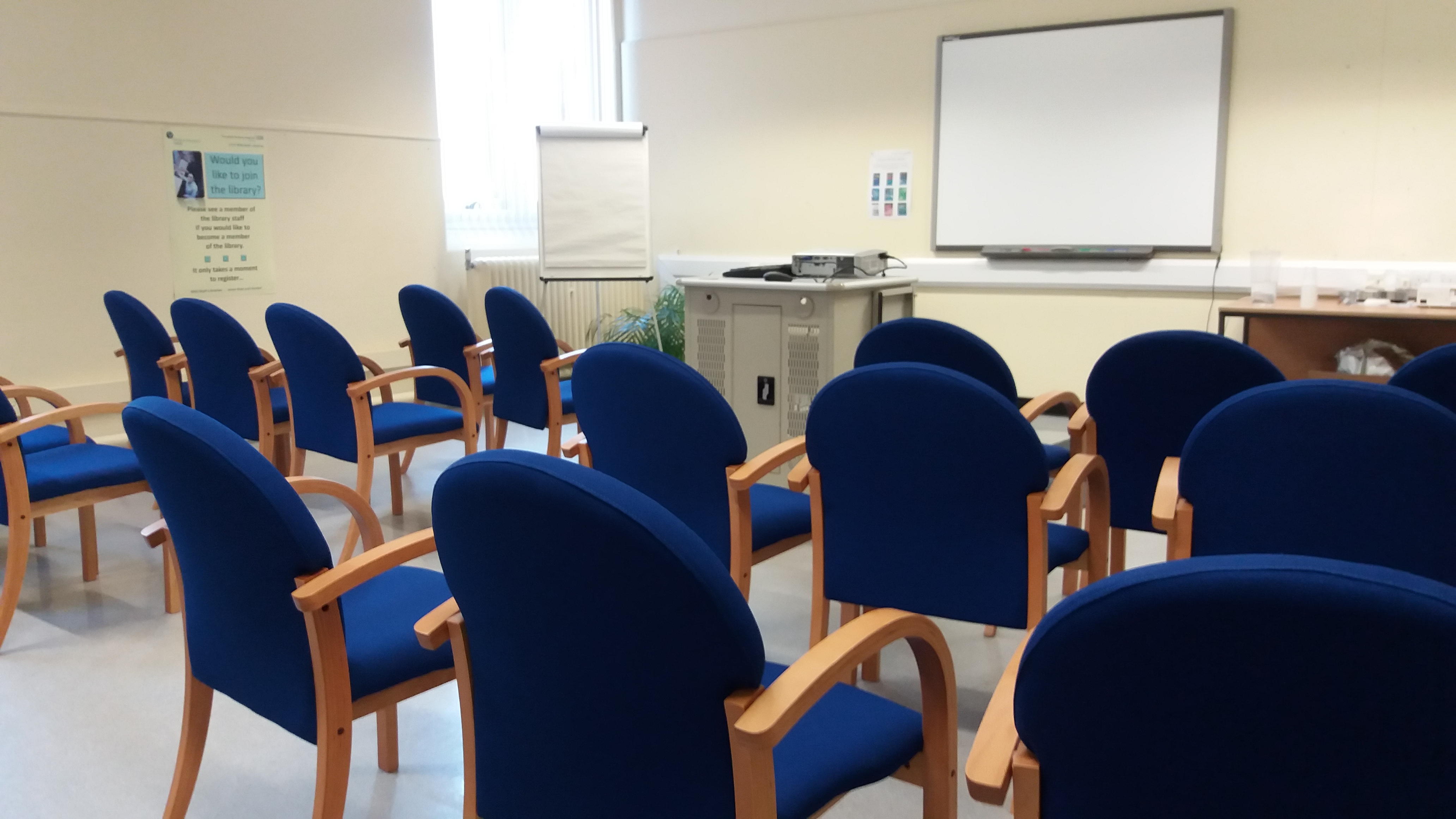 Training room with chairs in rows facing a white board.