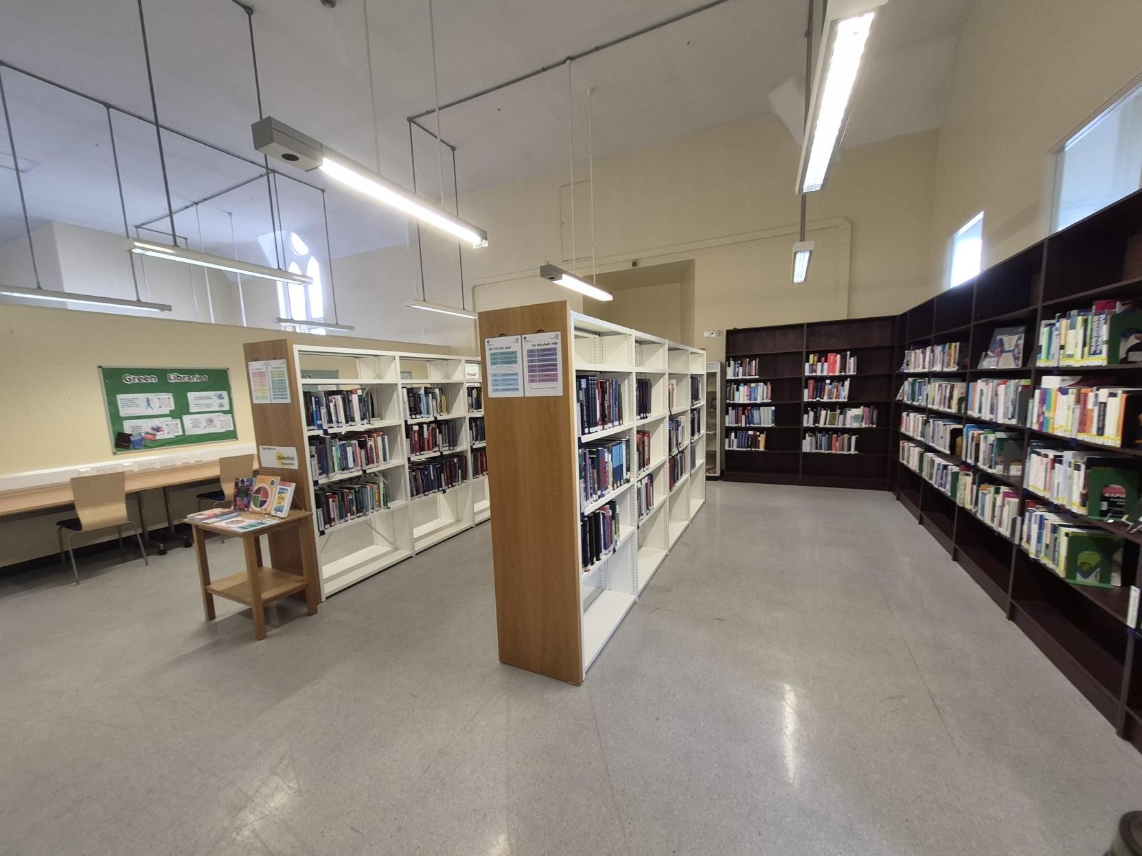 Study desks against wall, displays on wall, book shelves
