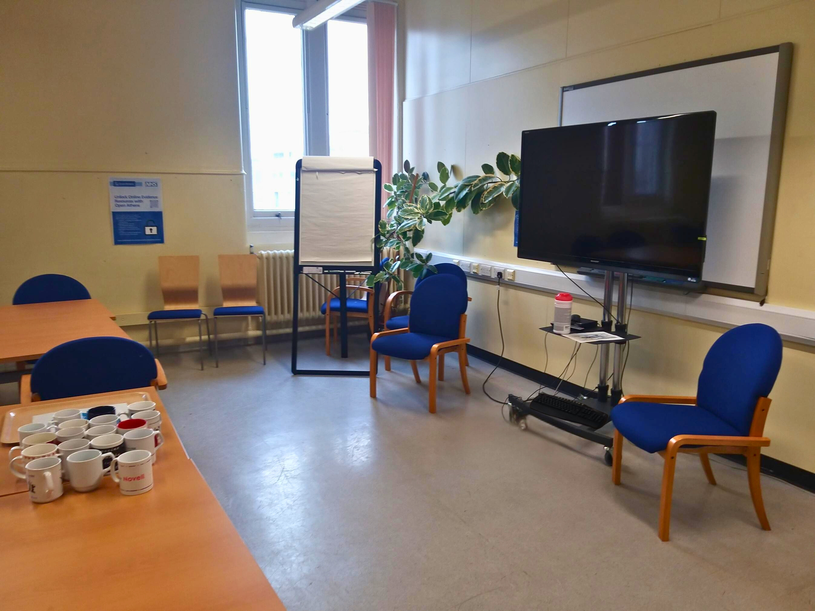 large fold out tables, chairs and moveable TV at front